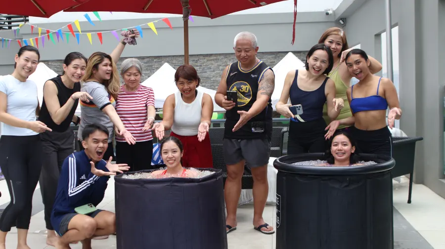 The group gathered and smiling around the ice tubs after the session