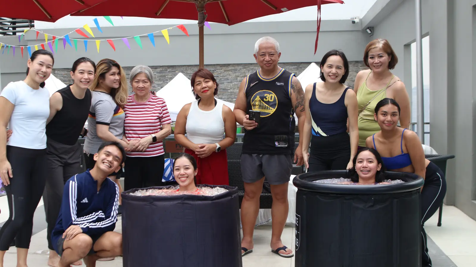 A team posing together around the ice tubs on a rooftop