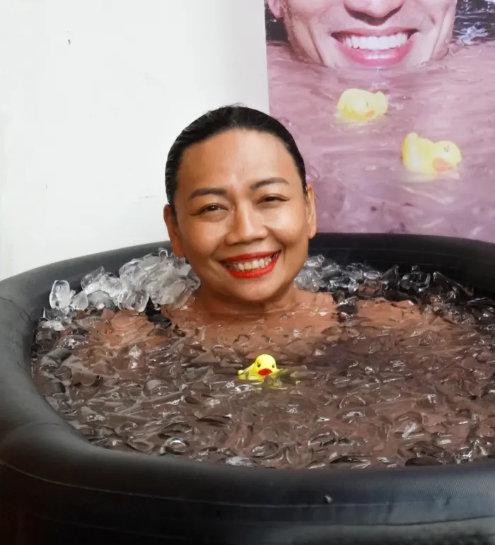 Rina smiling, shoulder-deep in an ice bath